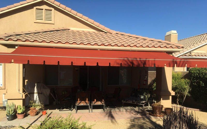 A house with a red awning on the porch.