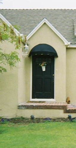 A large stone building with a canopy over the entrance.