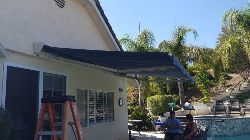 A patio with a table and chairs under a canopy