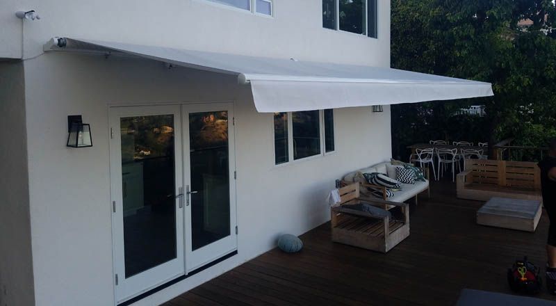 A white awning is covering the side of a house.