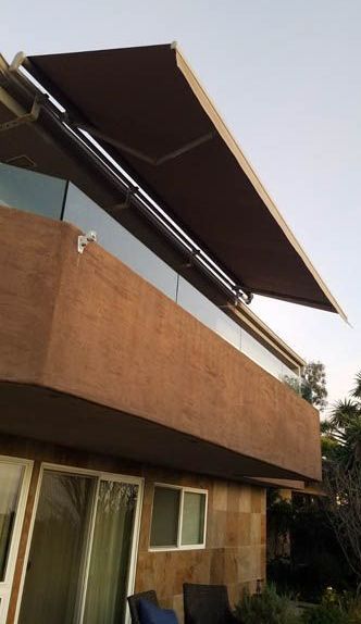 A balcony with a brown awning over it