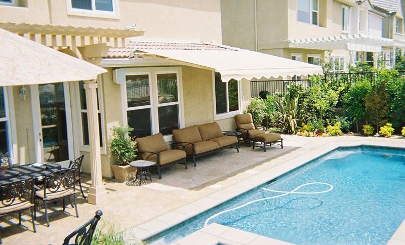 A house with a swimming pool and patio furniture