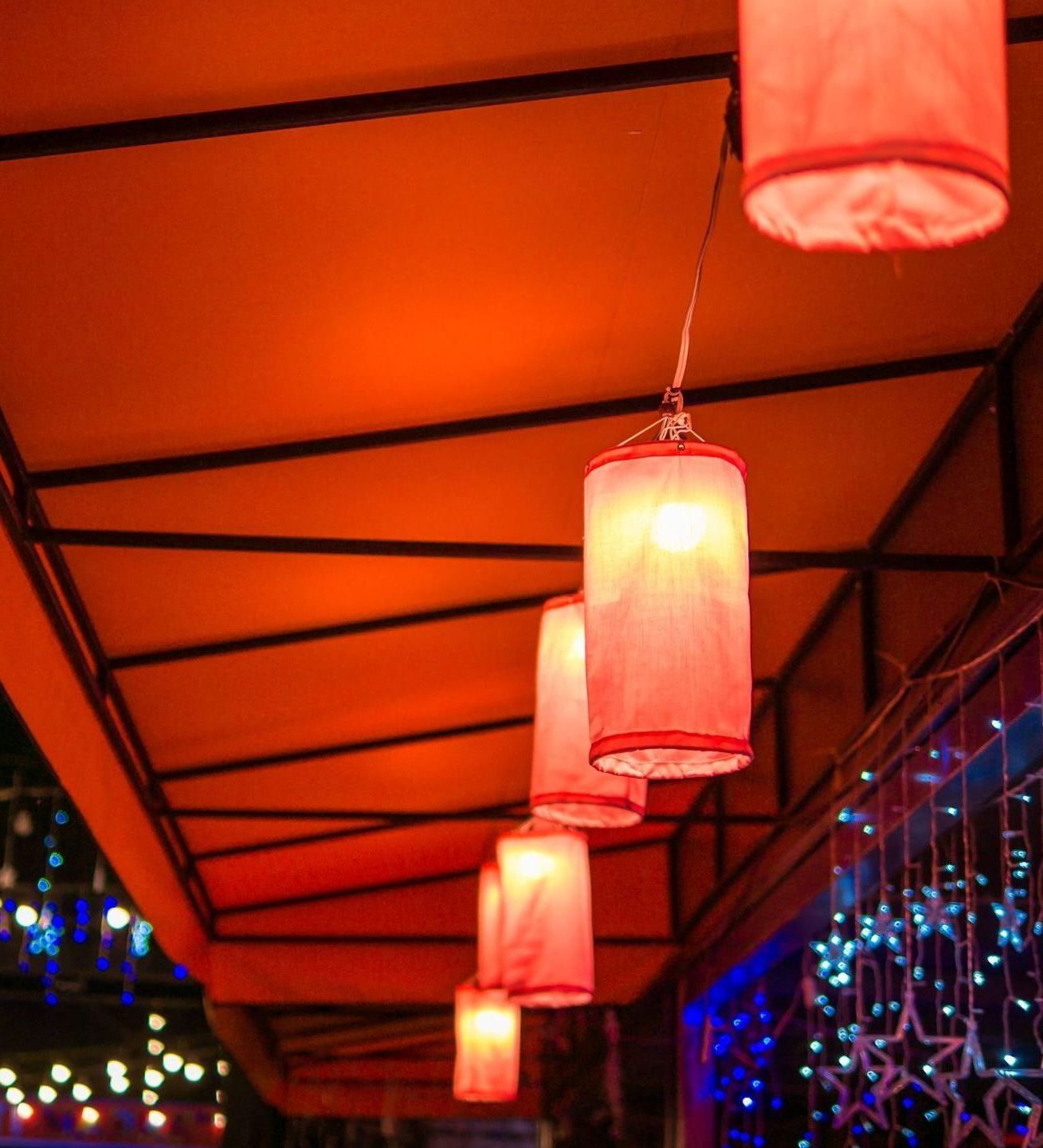 A row of red lanterns hanging from the ceiling