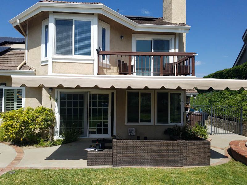 A large house with a large awning on the back of it.