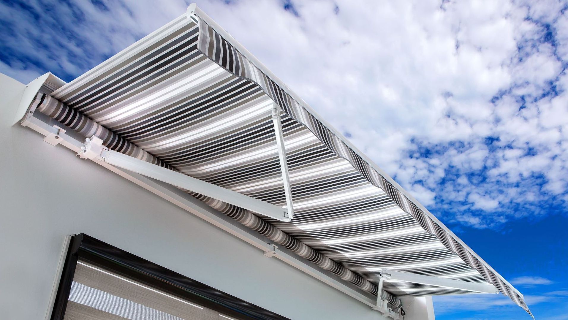 A white awning is sitting on top of a white building.