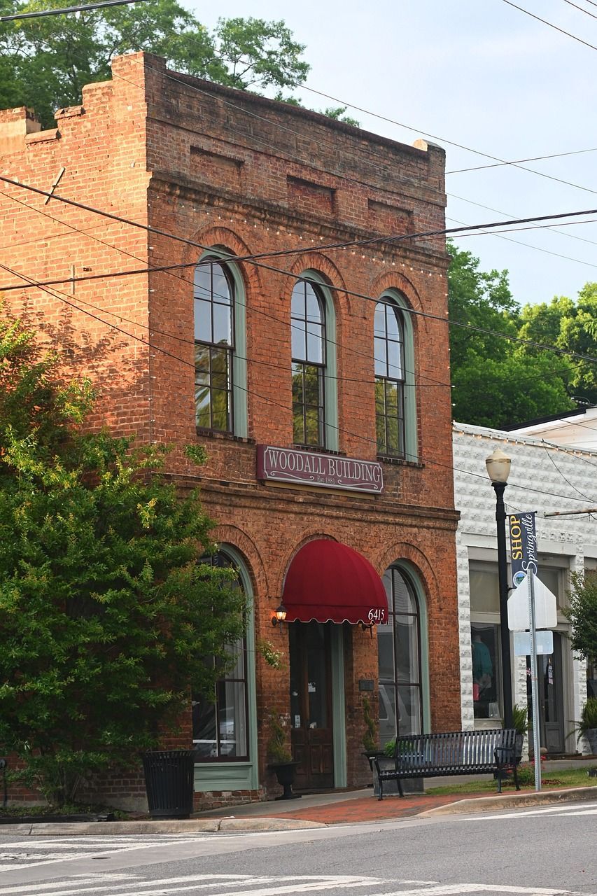 A brick building with a red awning on the front of it