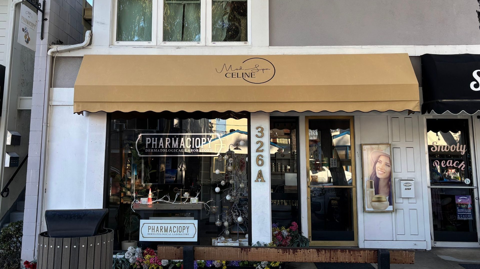 Storefront with a beige awning and the name 