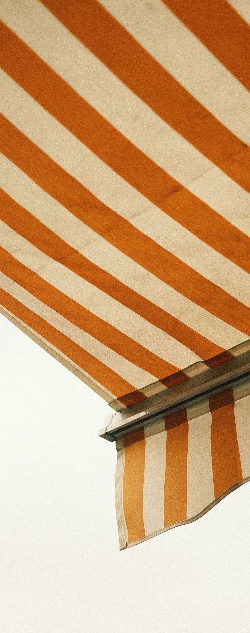 A close up of a striped awning on a white background.