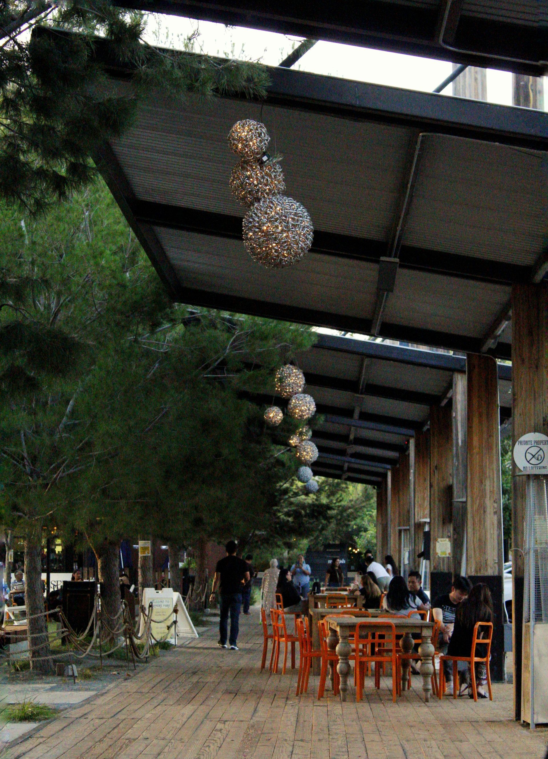 A restaurant with tables and chairs under a canopy