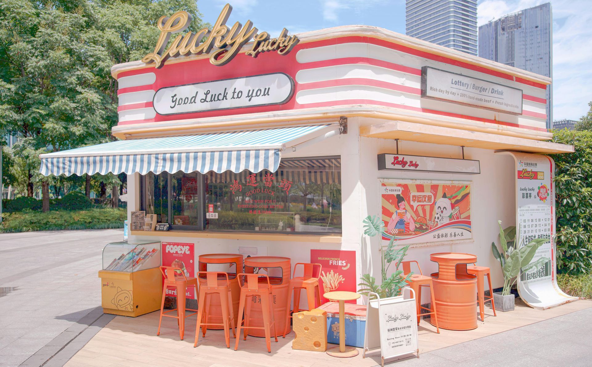A small restaurant with tables and chairs in front of it.