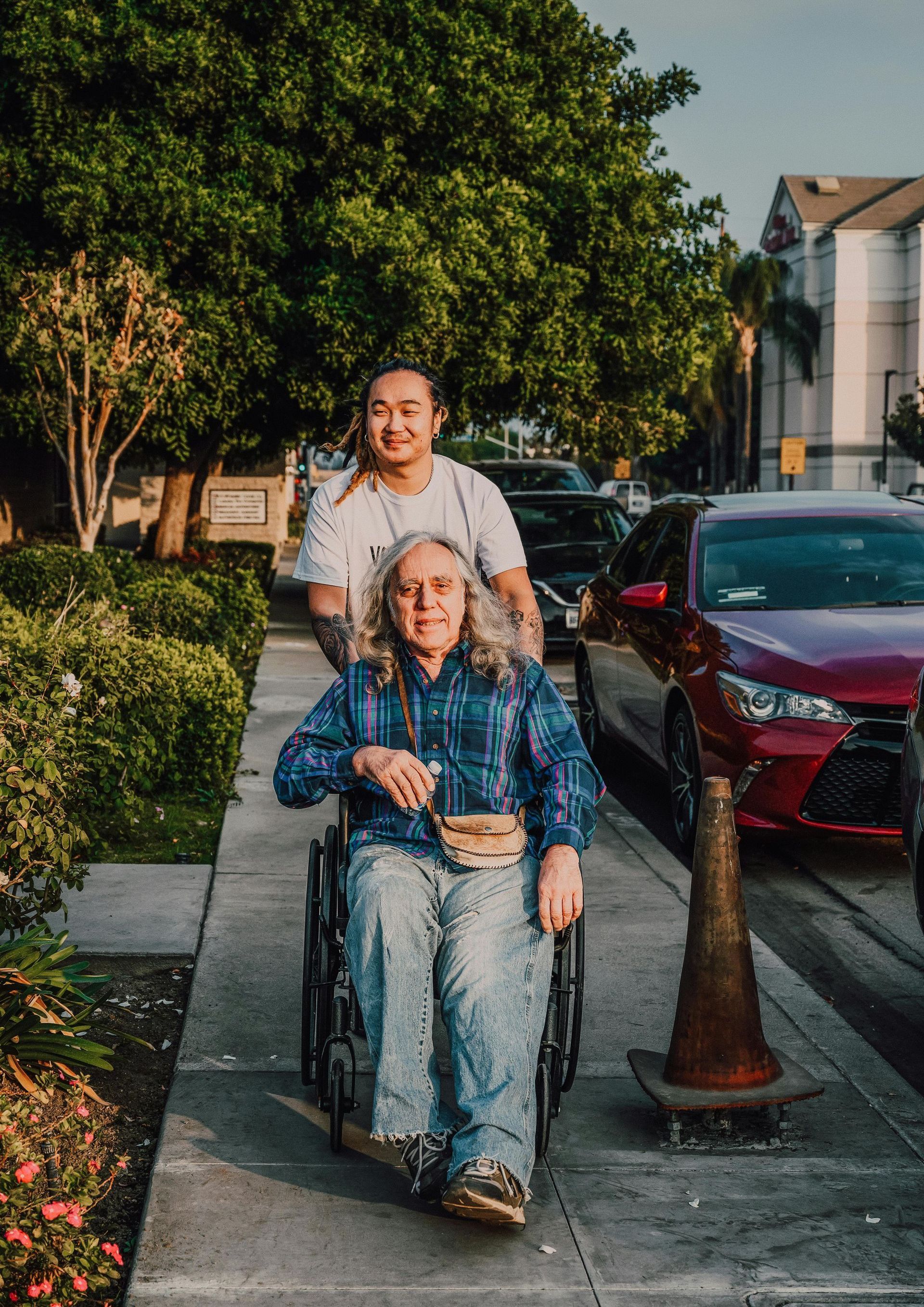 a man pushing a woman in a wheelchair