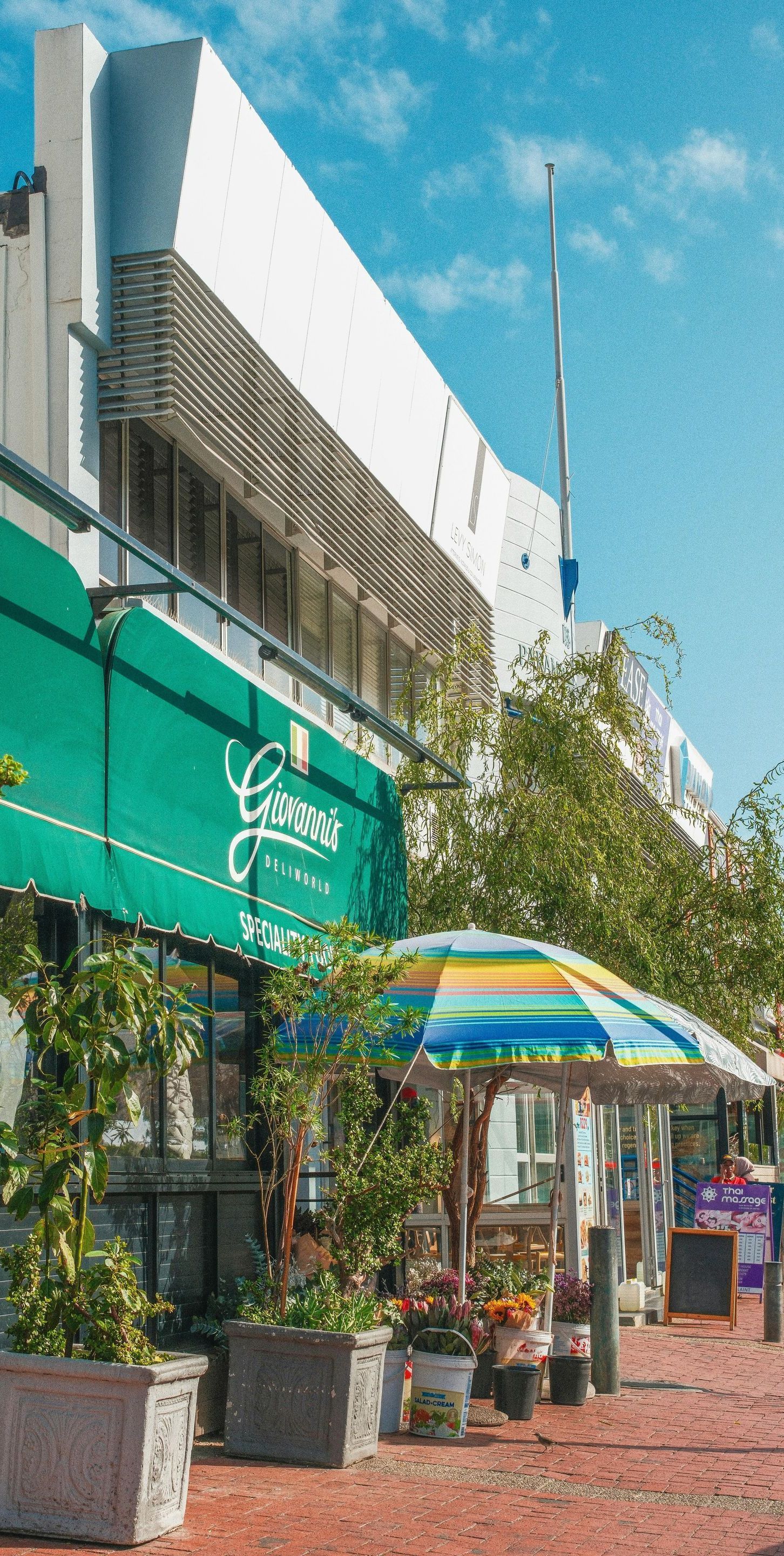 A green awning is on the side of a building