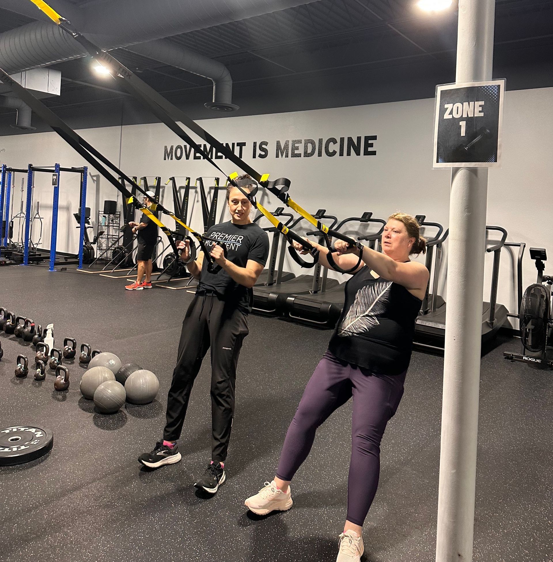 A gym with a sign that says movement is medicine