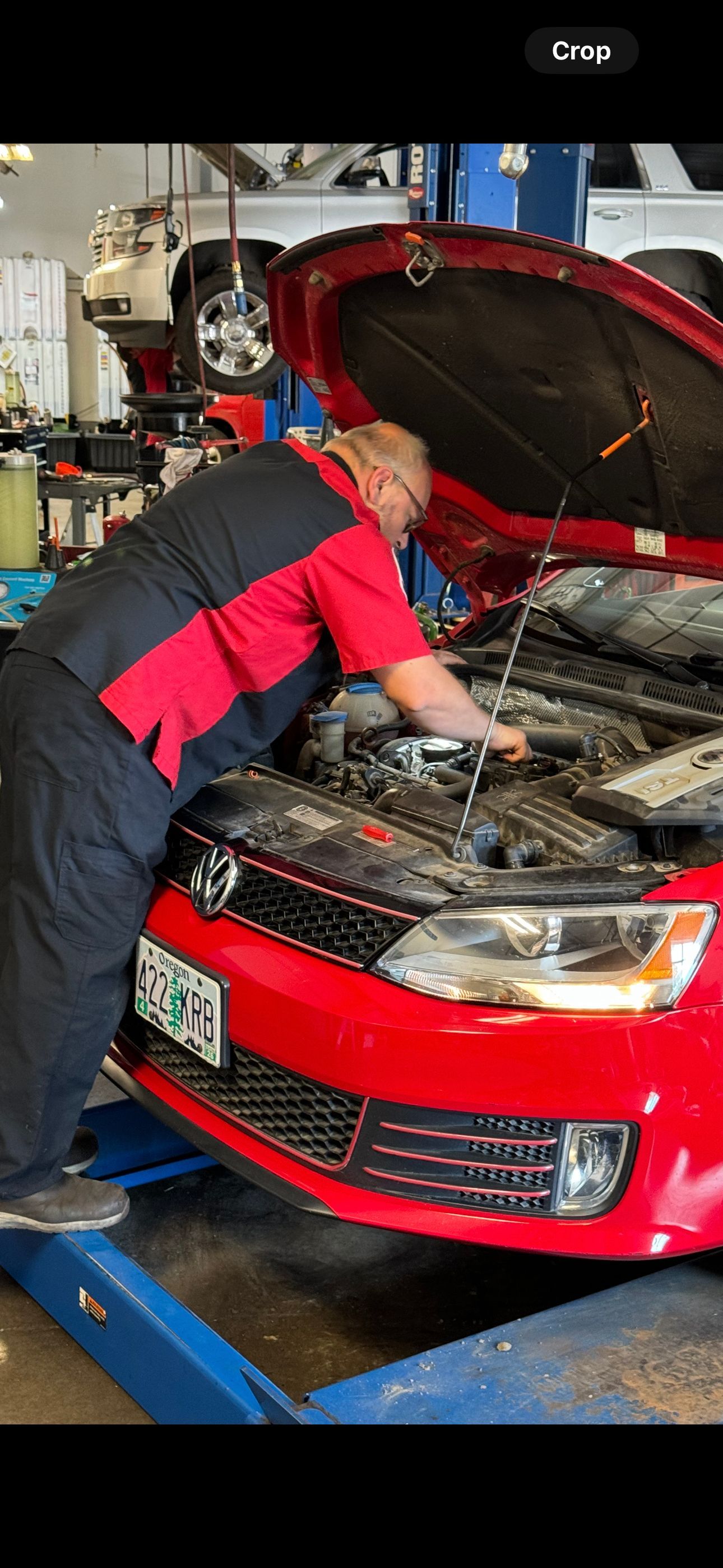 Mechanic Checking Oil in Albany, OR - Lava Auto Tire Service & Car Wash