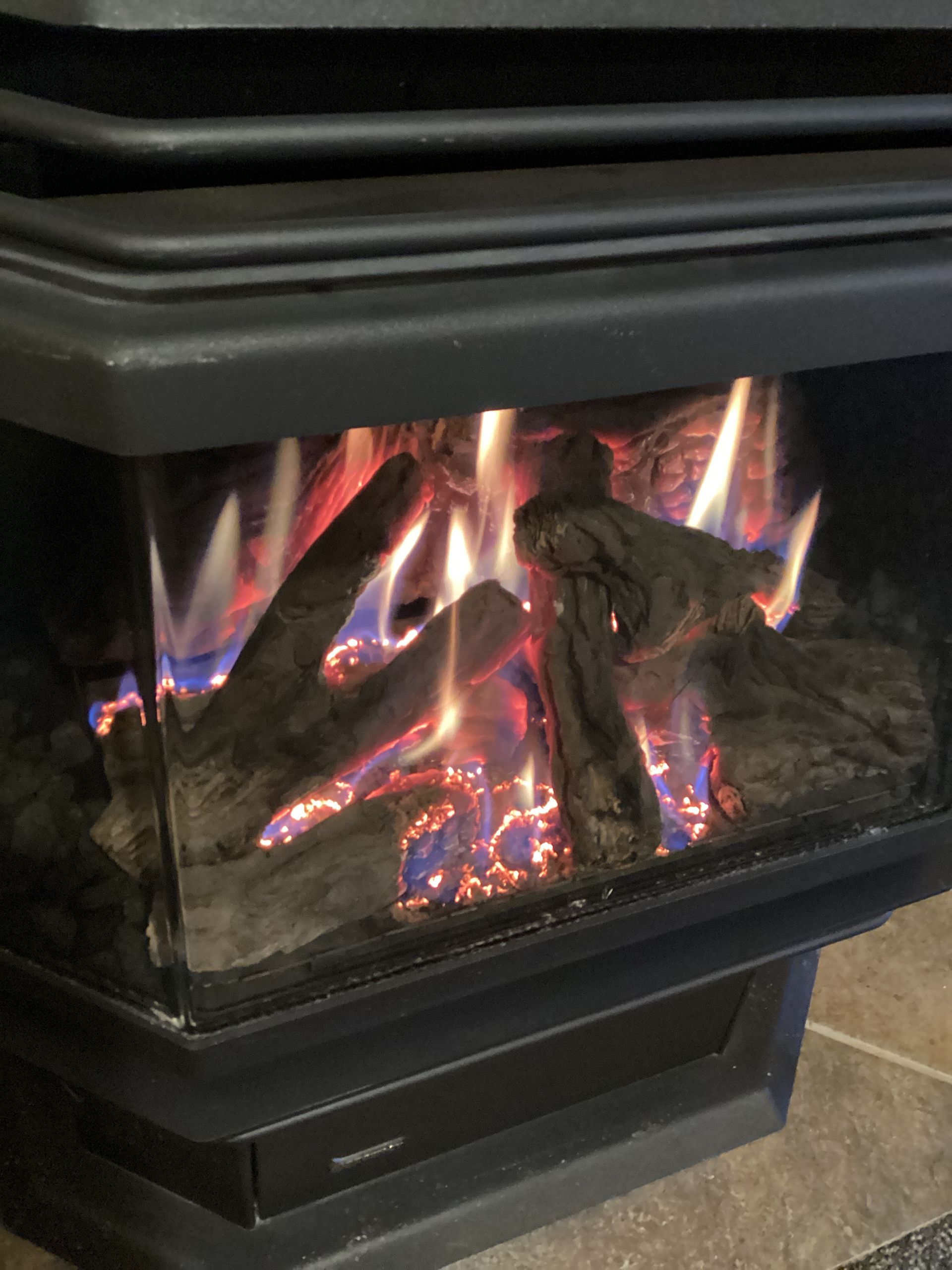 Comfort Pro - A close up of a fireplace with flames coming out of it