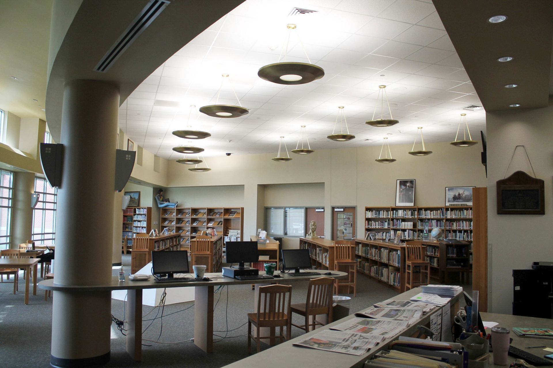 The inside of a library with tables and chairs