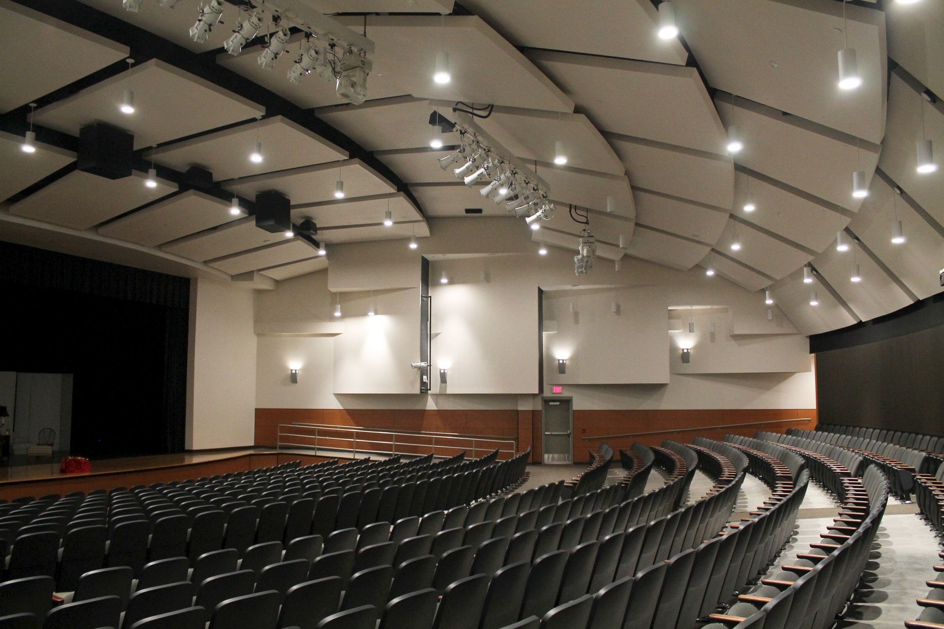 A large auditorium with rows of seats and a stage