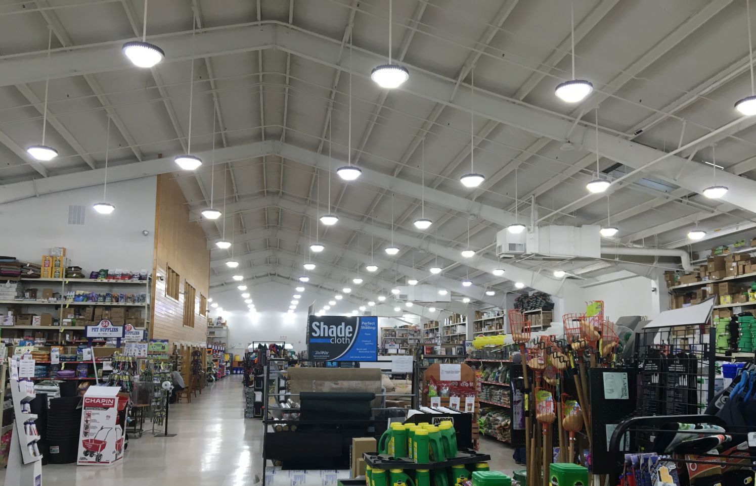 The inside of a large store with lots of shelves and lights.