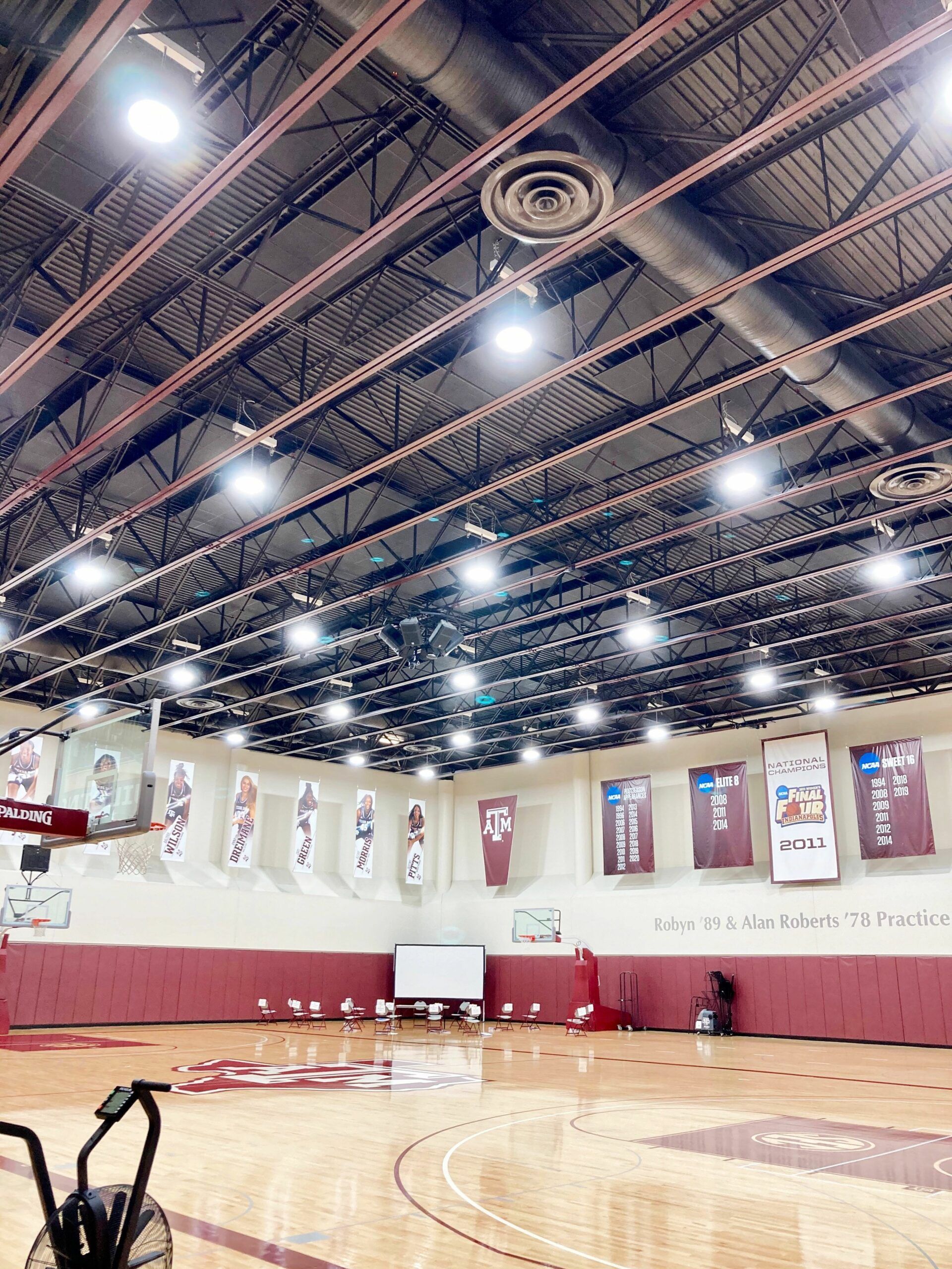 A basketball court with a lot of lights on it