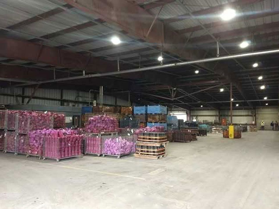 A large warehouse filled with lots of boxes and pallets.