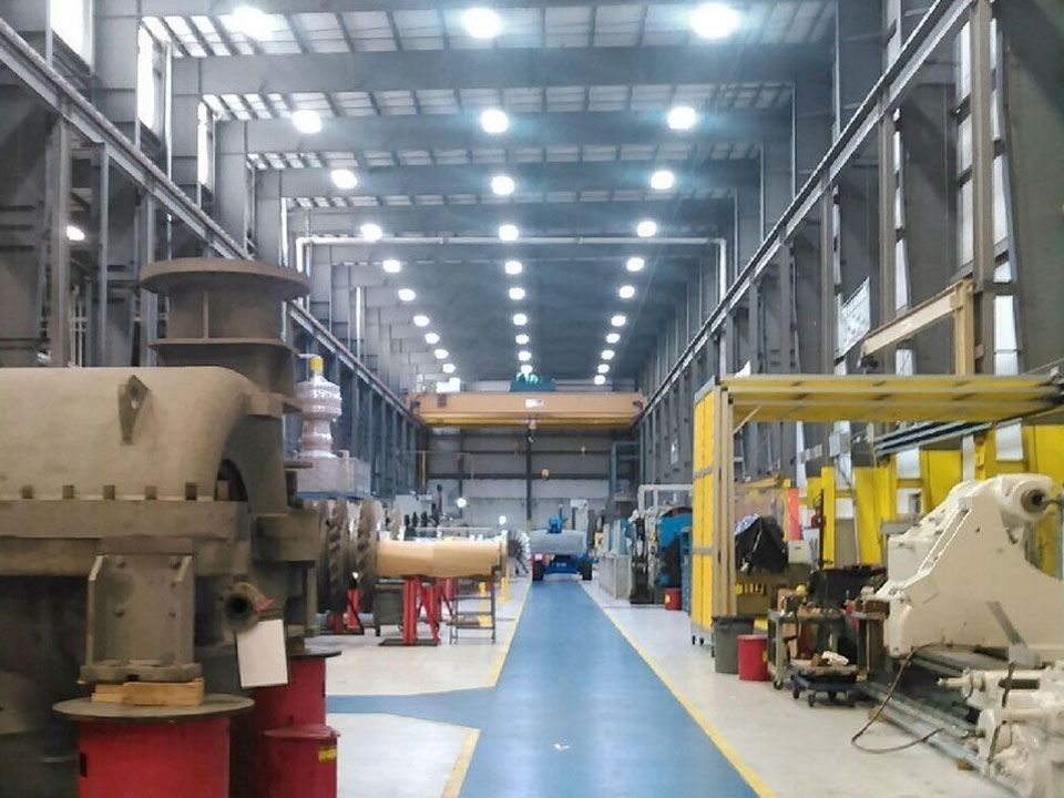 A large factory with a blue floor and lots of machinery