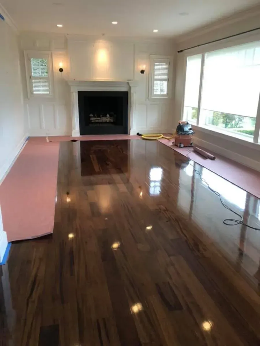 A living room with hardwood floors and a fireplace
