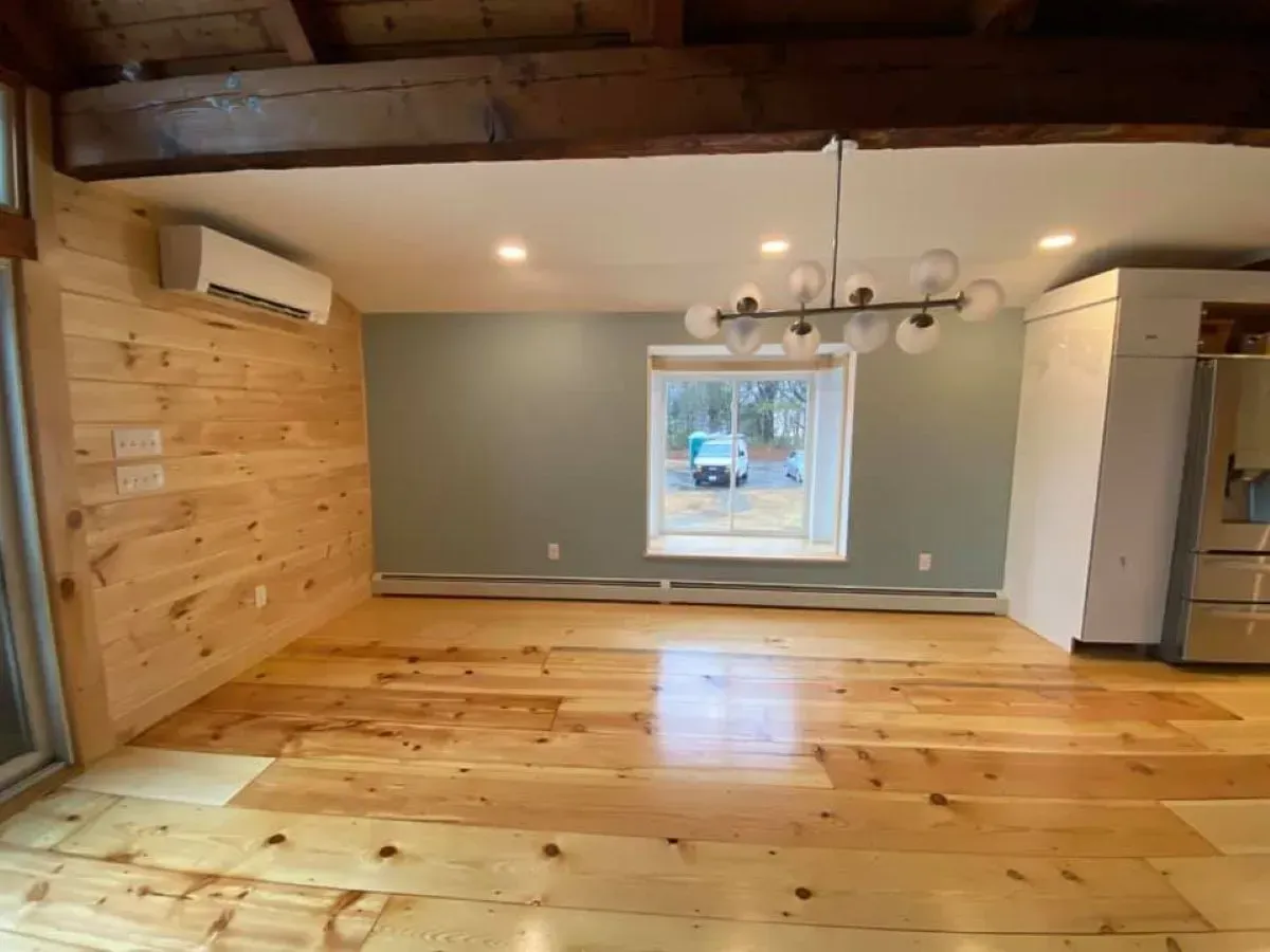 A living room with hardwood floors and a window.