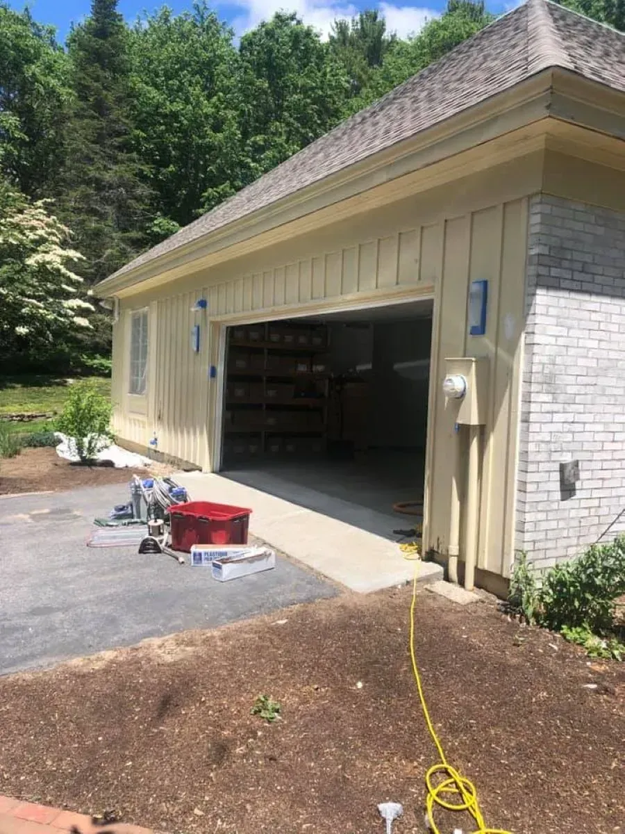A garage with a large garage door is being painted.