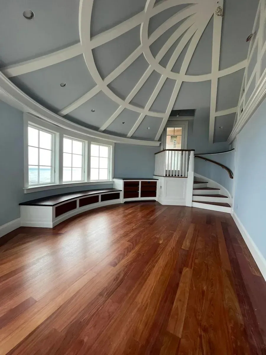 An empty room with a curved ceiling and stairs
