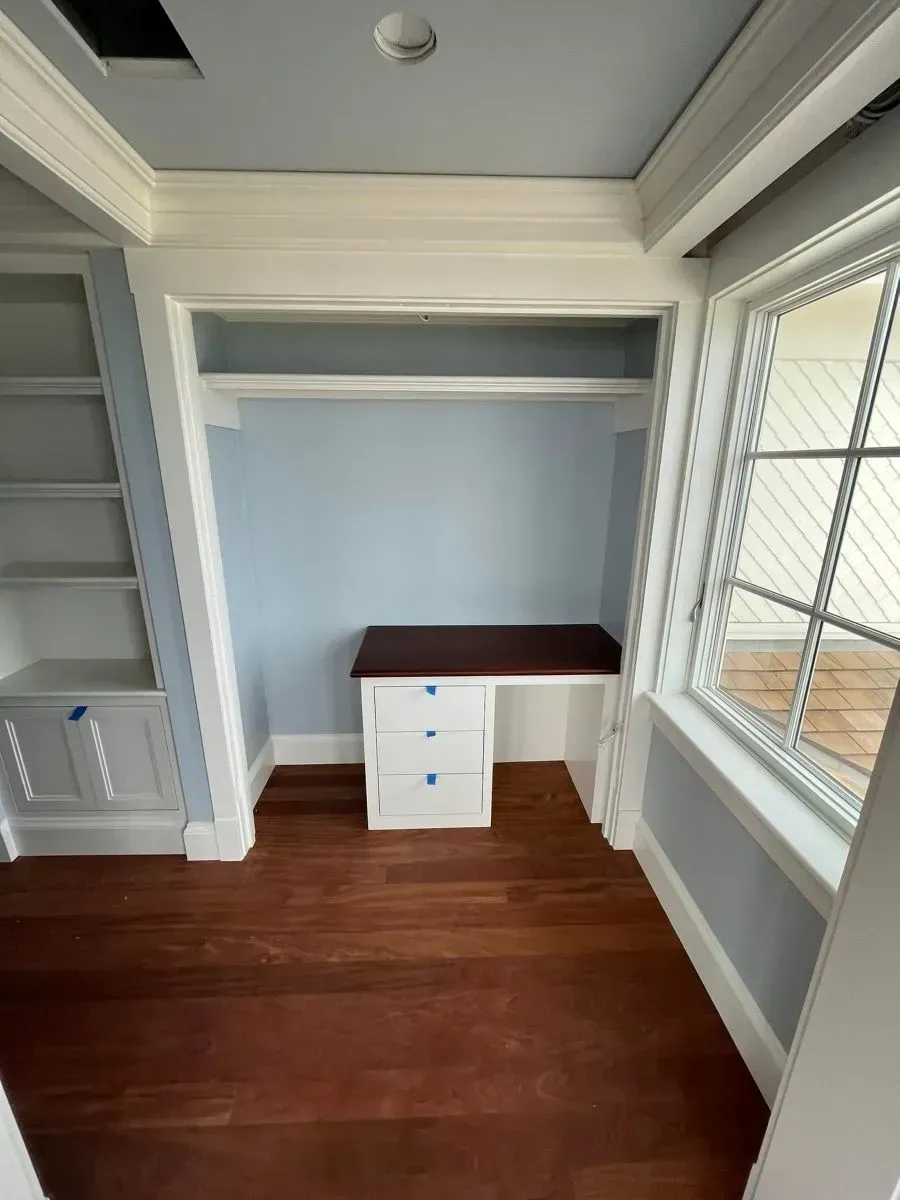 An empty room with a desk and a window