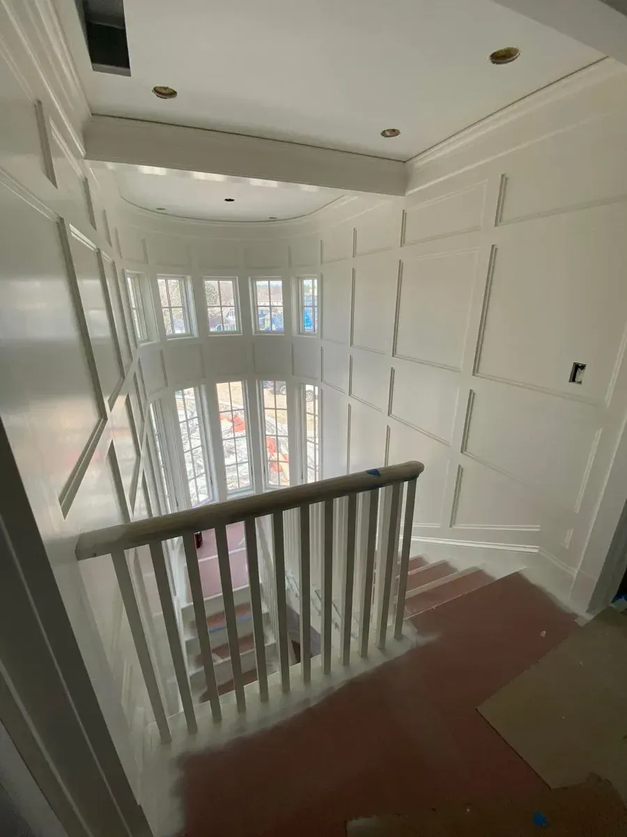 A view of a staircase from the second floor of a house.