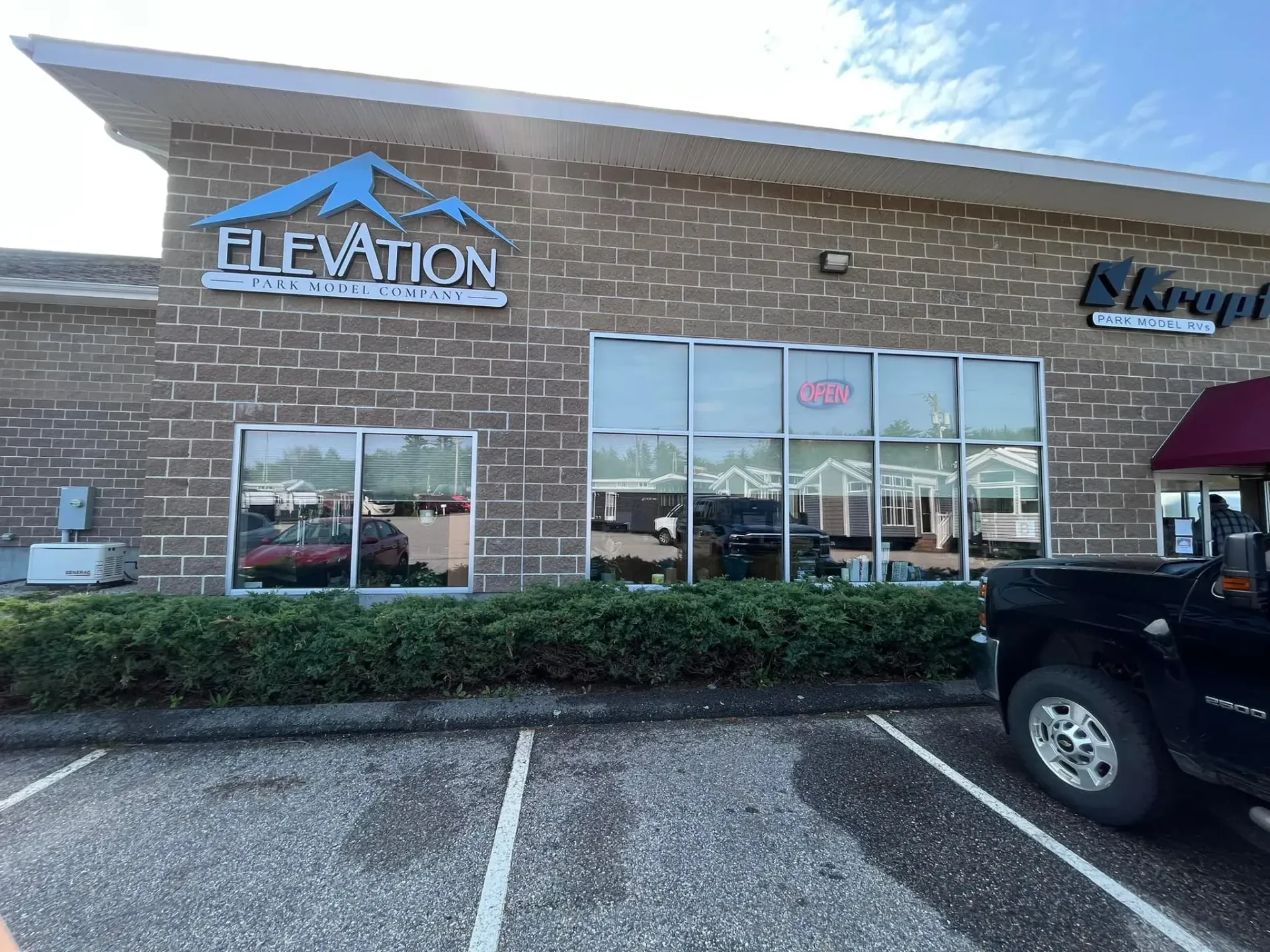 A truck is parked in front of a brick building.