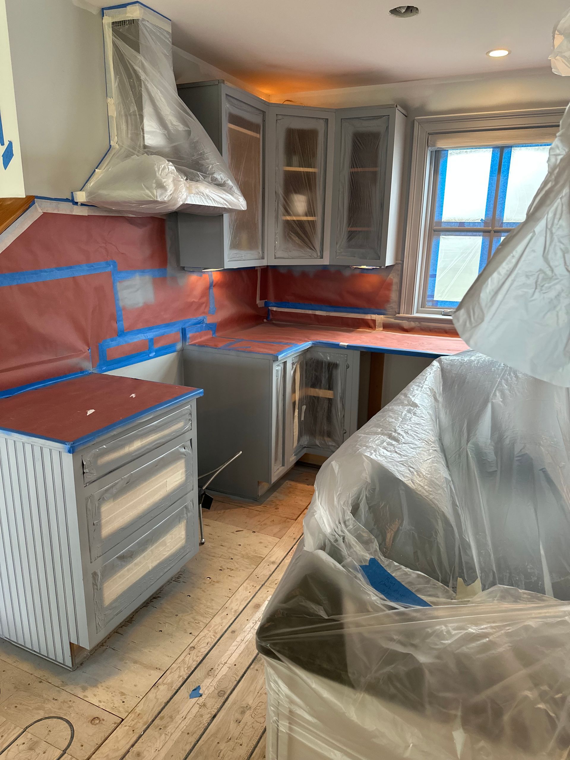 Before kitchen covered for painting job in Kennebunk
