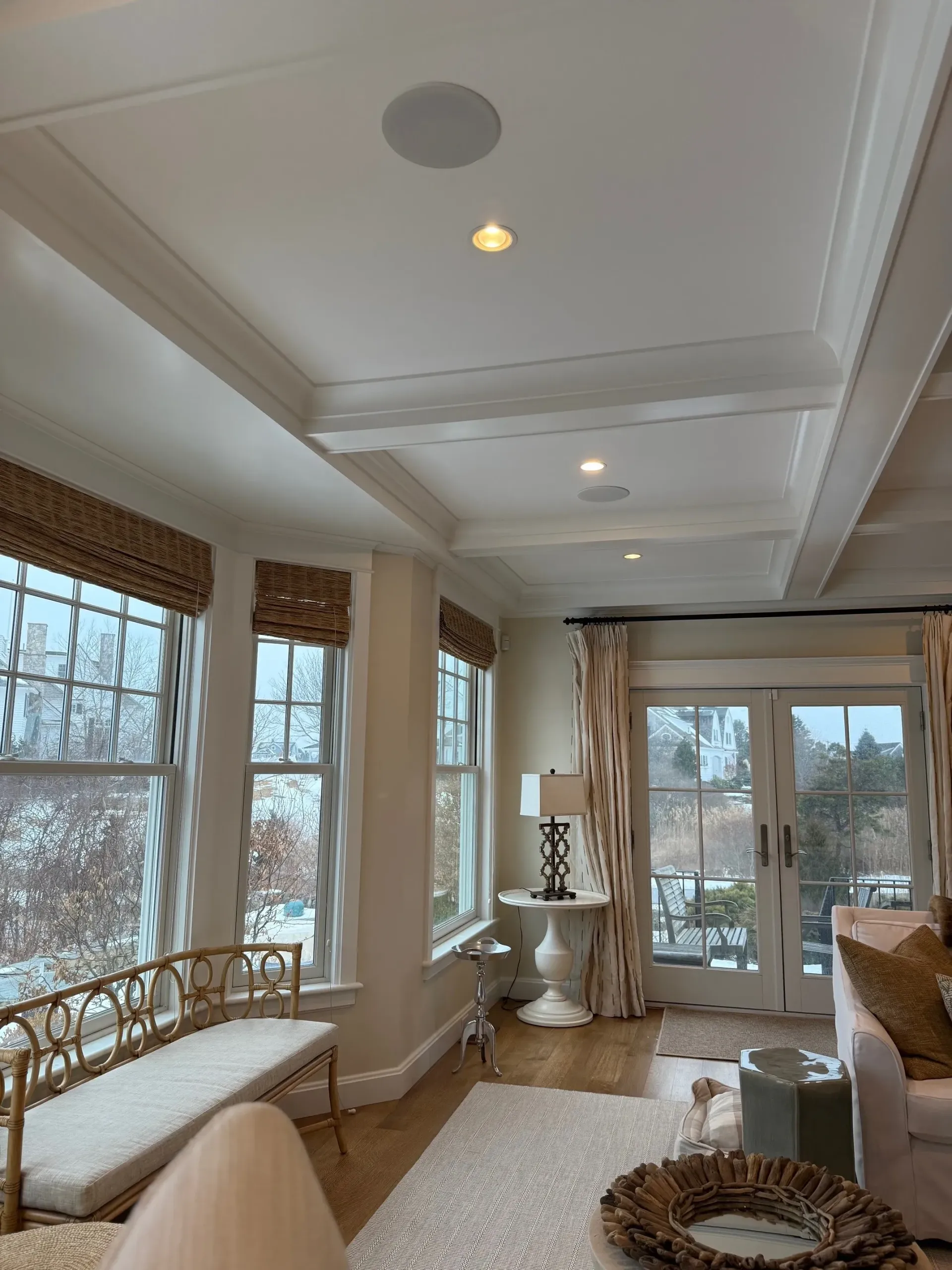 A living room with a lot of windows and furniture