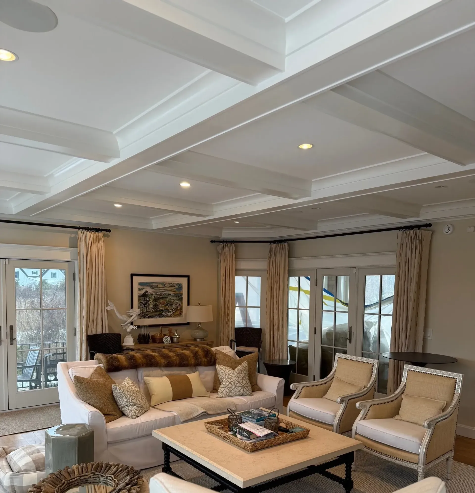 A living room with a couch and chairs and a coffee table