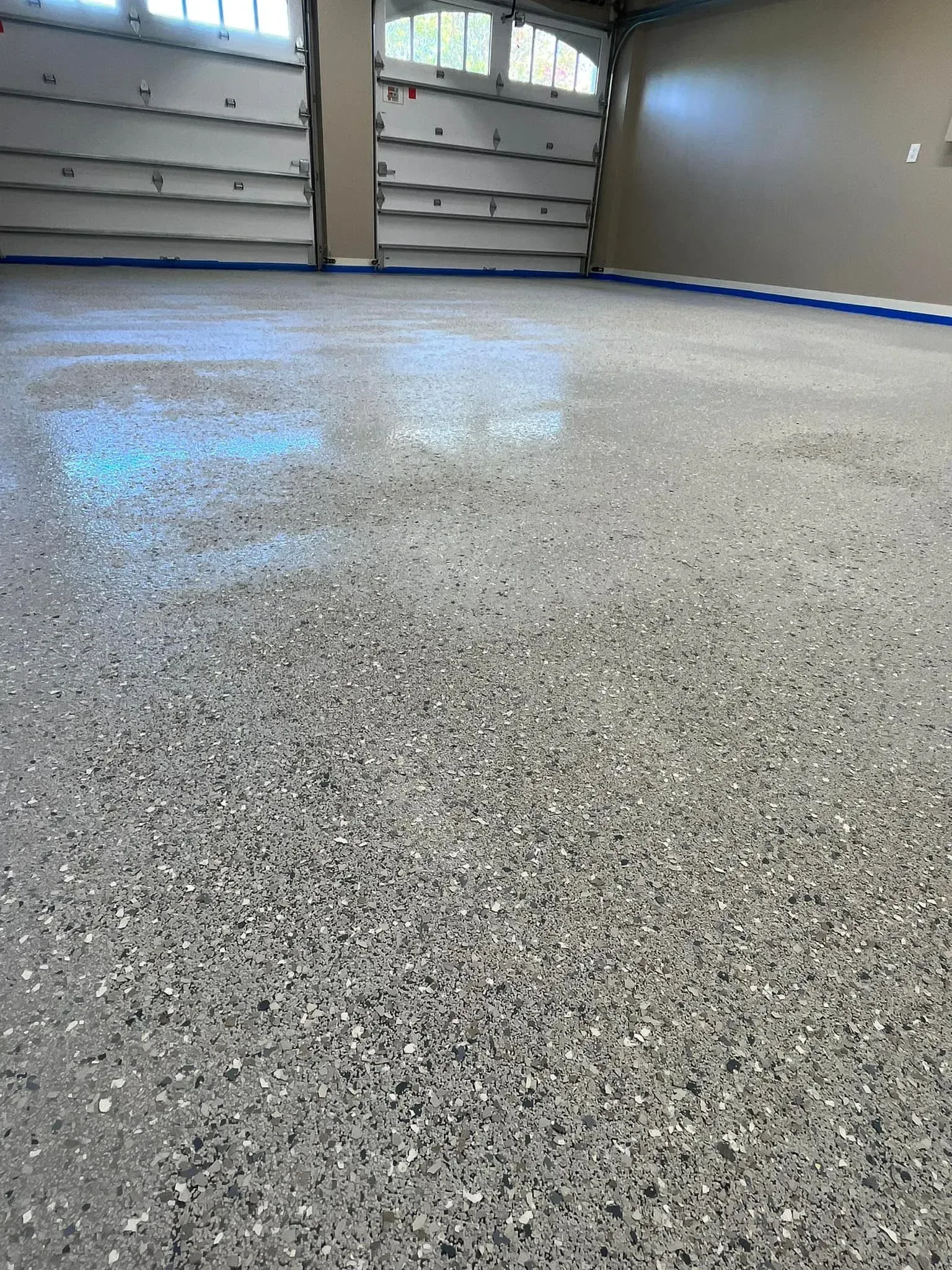 A garage with a concrete floor and a garage door.