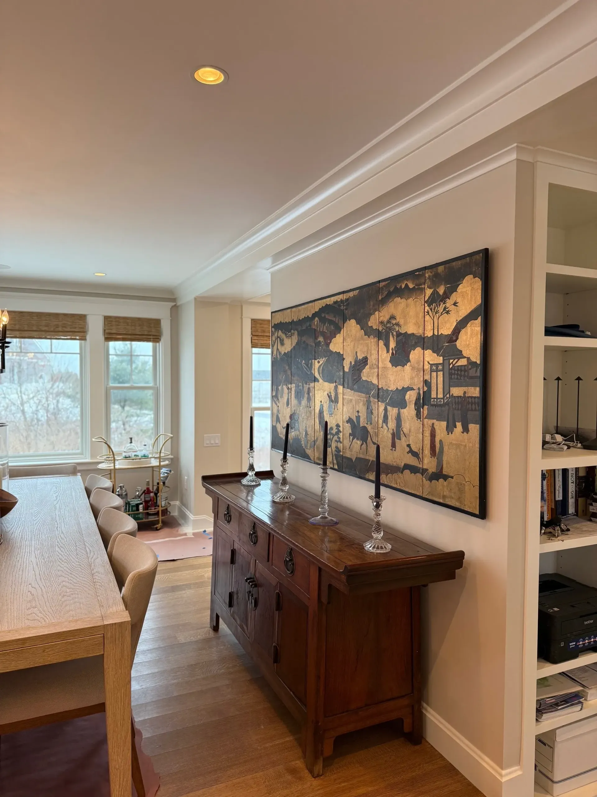A window with a grid on it is sitting on top of a pile of gravel.