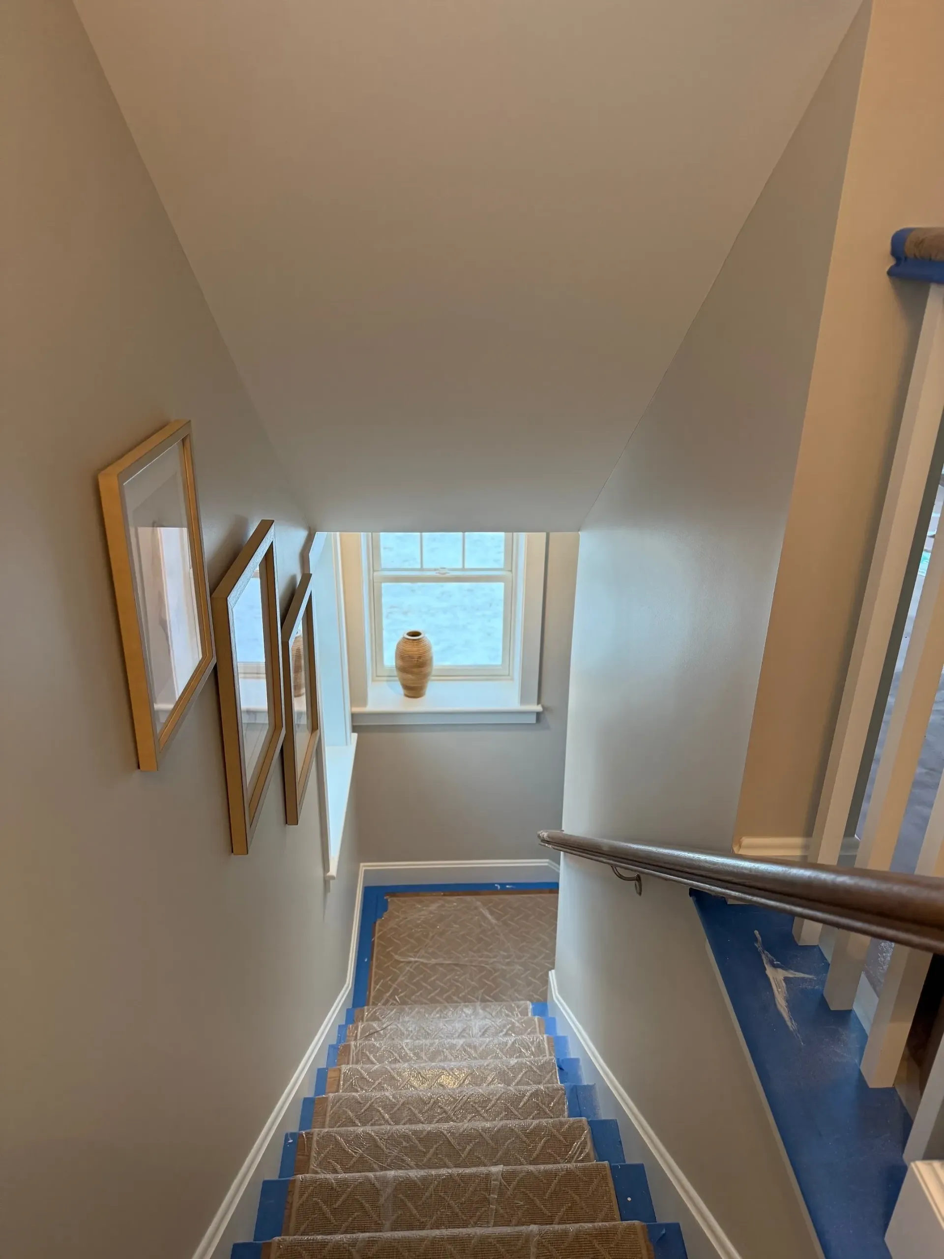 A set of stairs leading up to a window in a house.