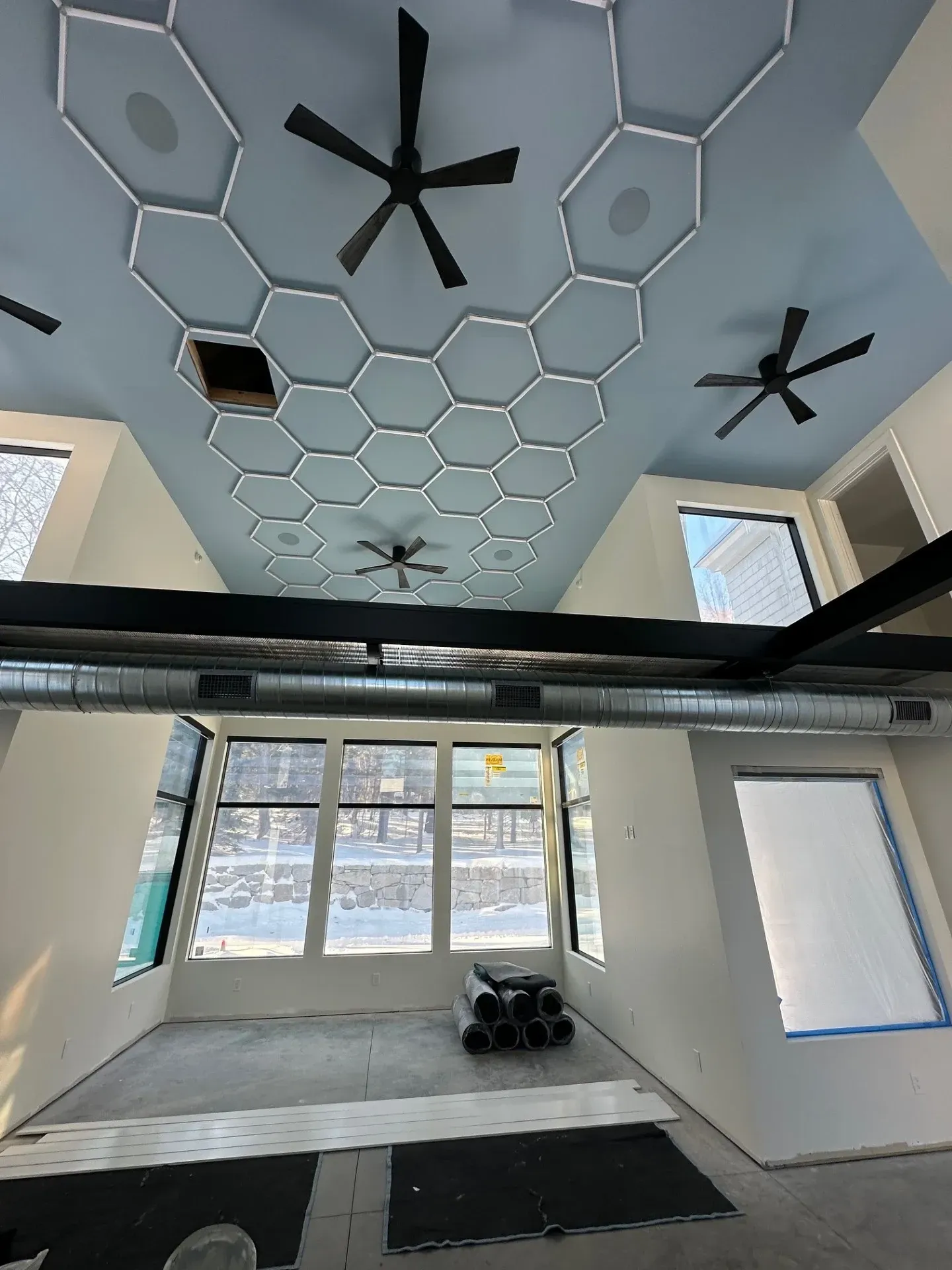 A room with a blue ceiling and a lot of windows