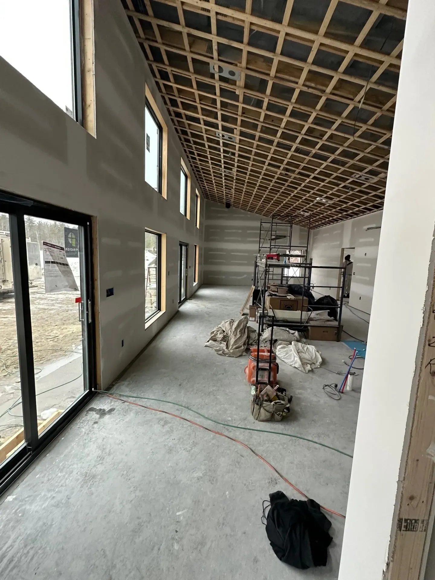 A large room with a lot of windows and a ceiling that is being built.