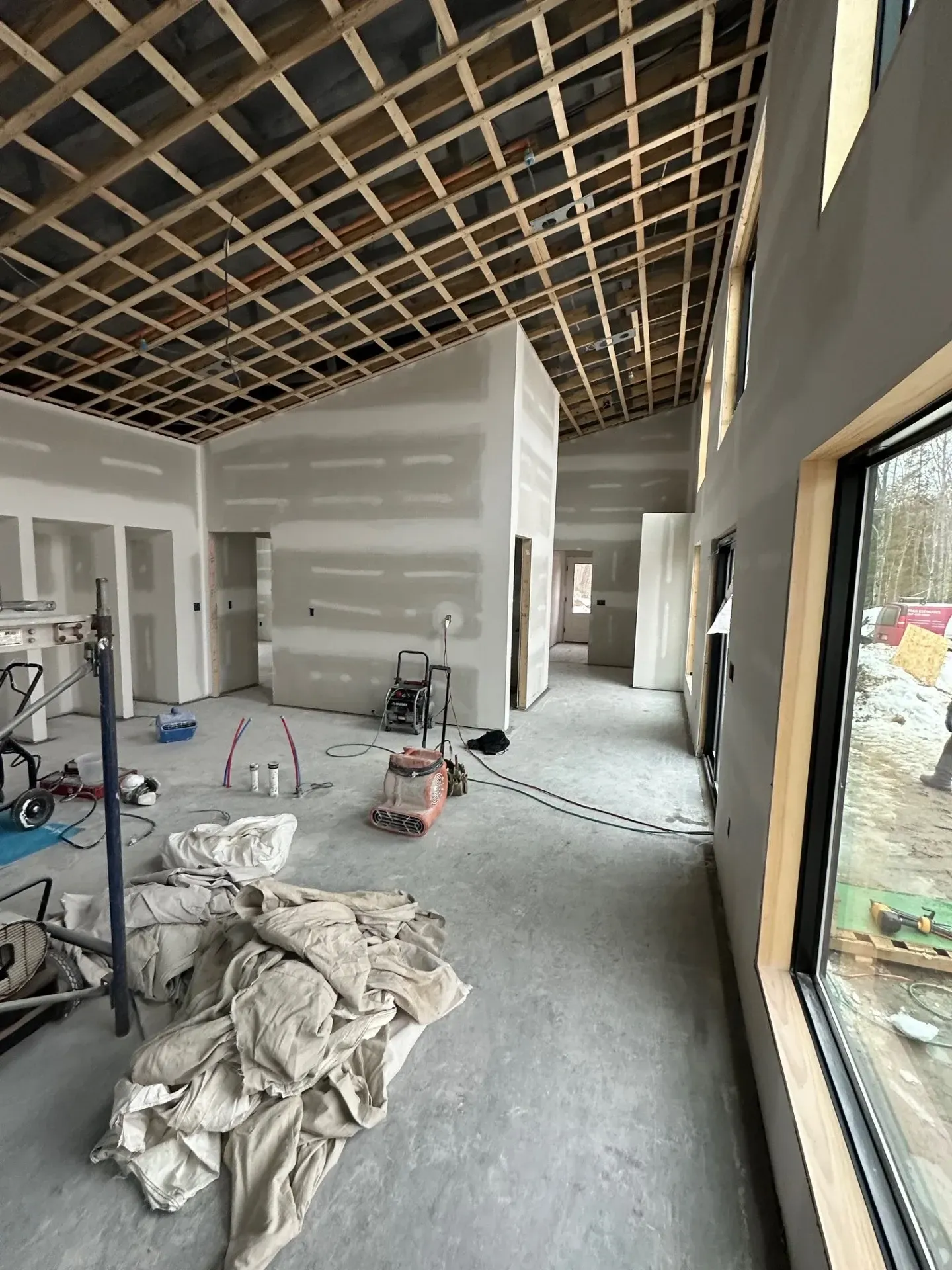 A large room with a ceiling that is being built.