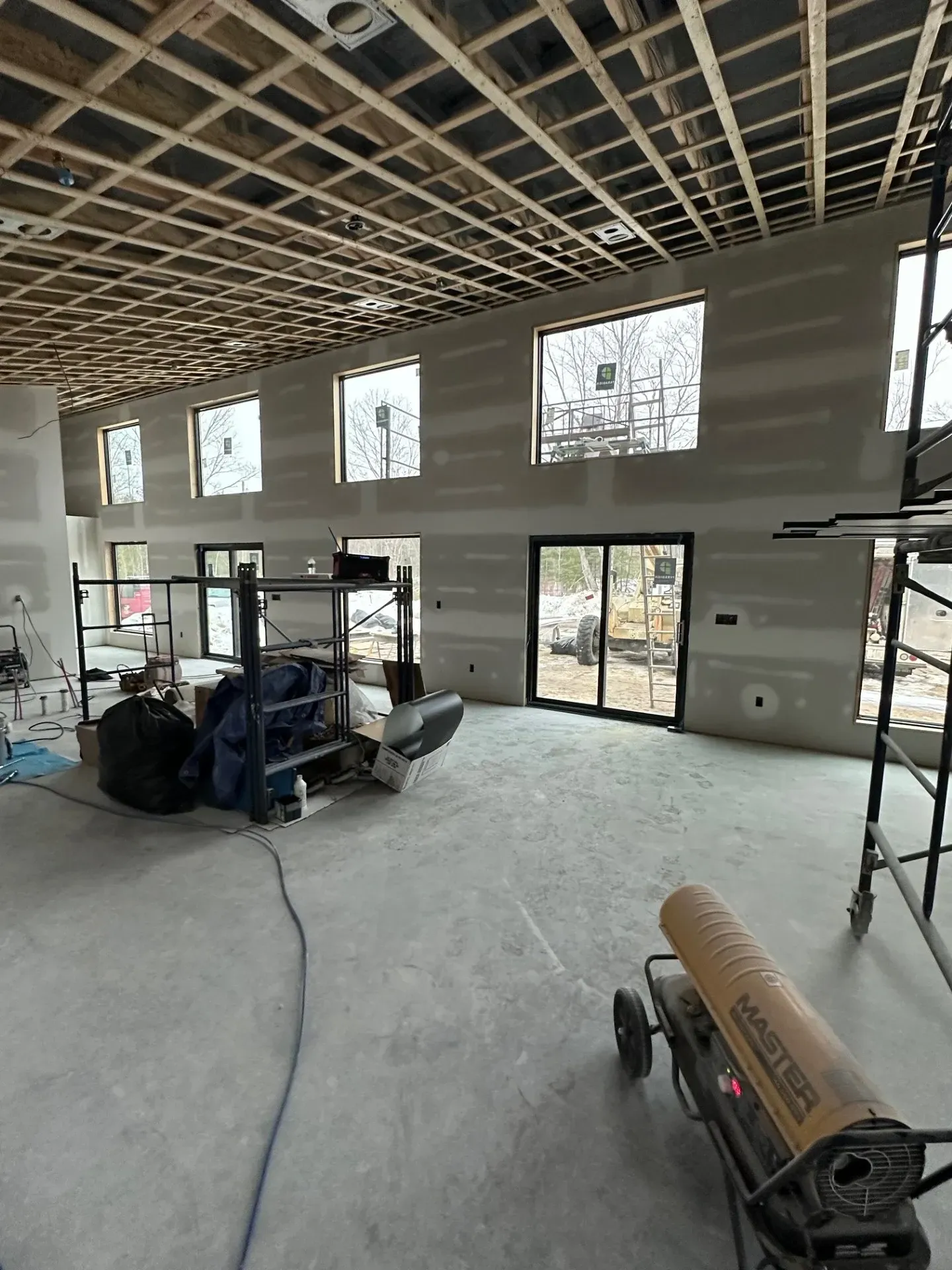 A large room with a lot of windows and a heater in the middle of it.