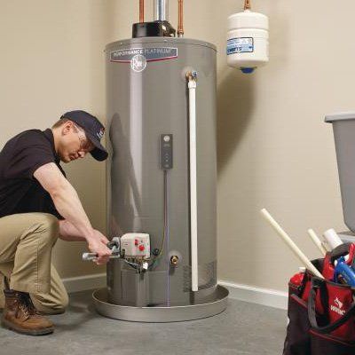 Man Fixing Water Heater — Overland Park, KS — AJ Plumbing Electric LLC