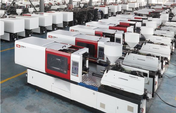 Rows of Hwamda injection molding machines in a factory setting.