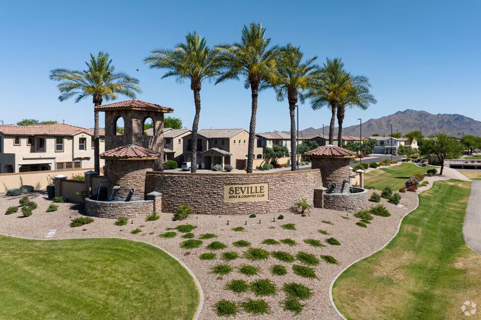 An aerial view of a residential area with palm trees and buildings.