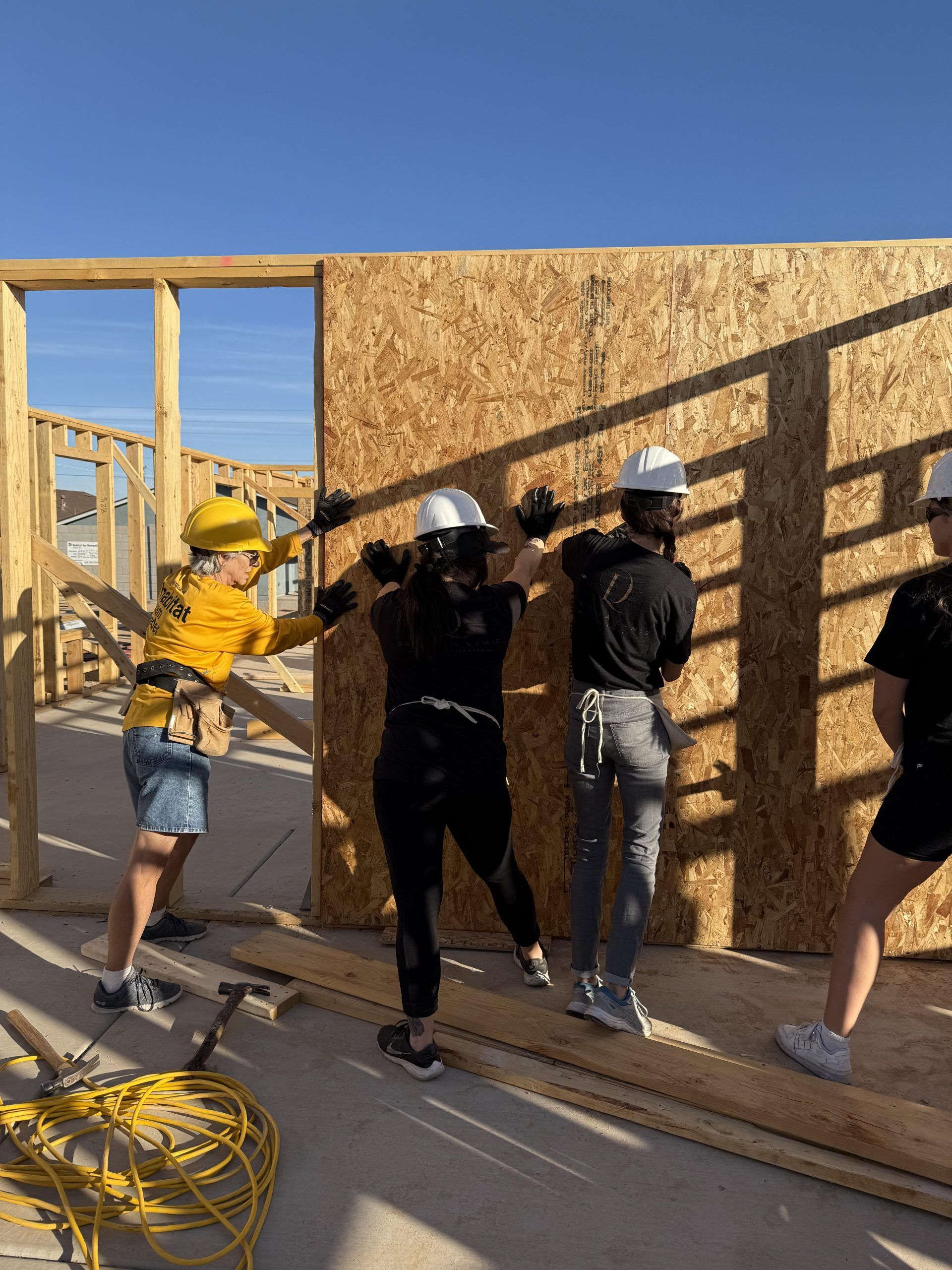 A group of people are working on a building under construction.