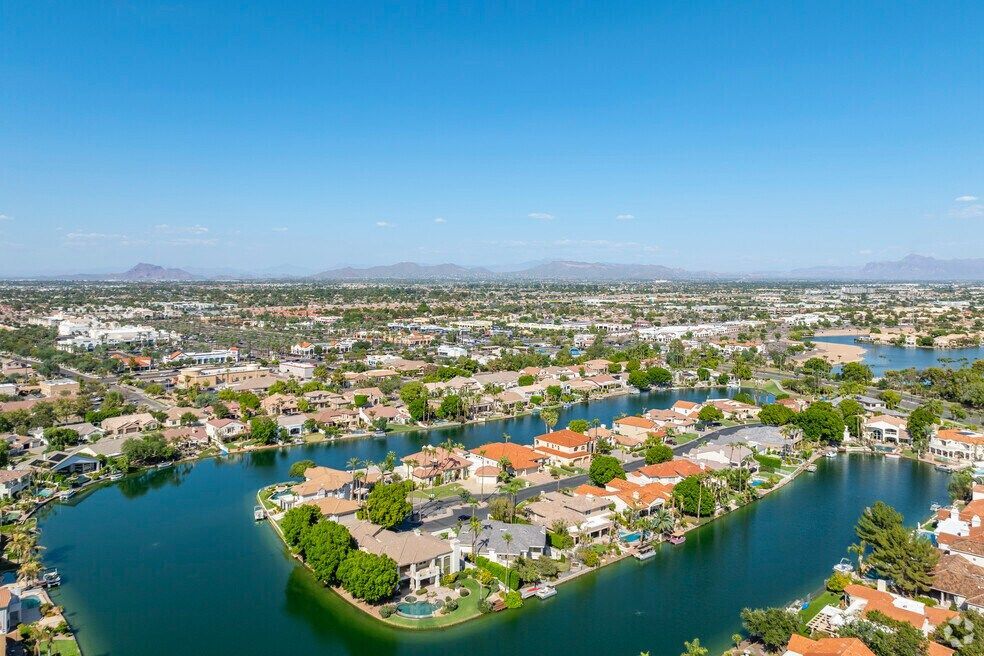 An aerial view of a residential area surrounded by a lake.