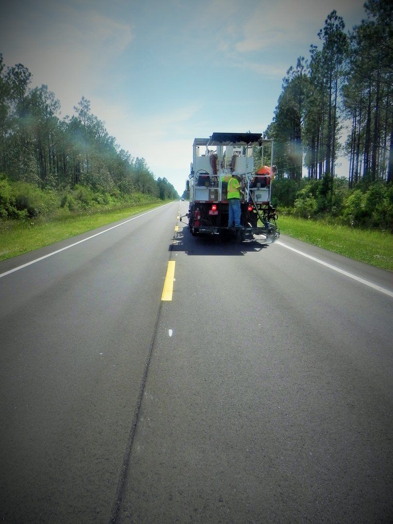 Painting the Road While Truck Is Moving — Pensacola, FL — Emerald Coast Striping
