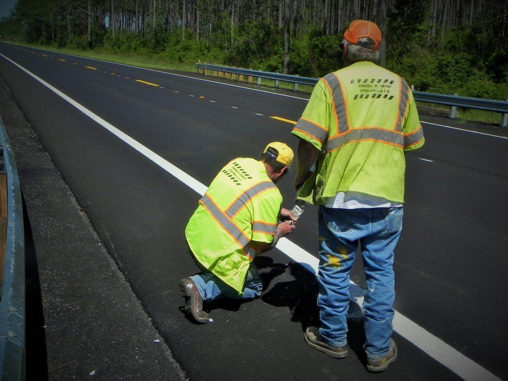 Two Men Checking the White Line — Pensacola, FL — Emerald Coast Striping