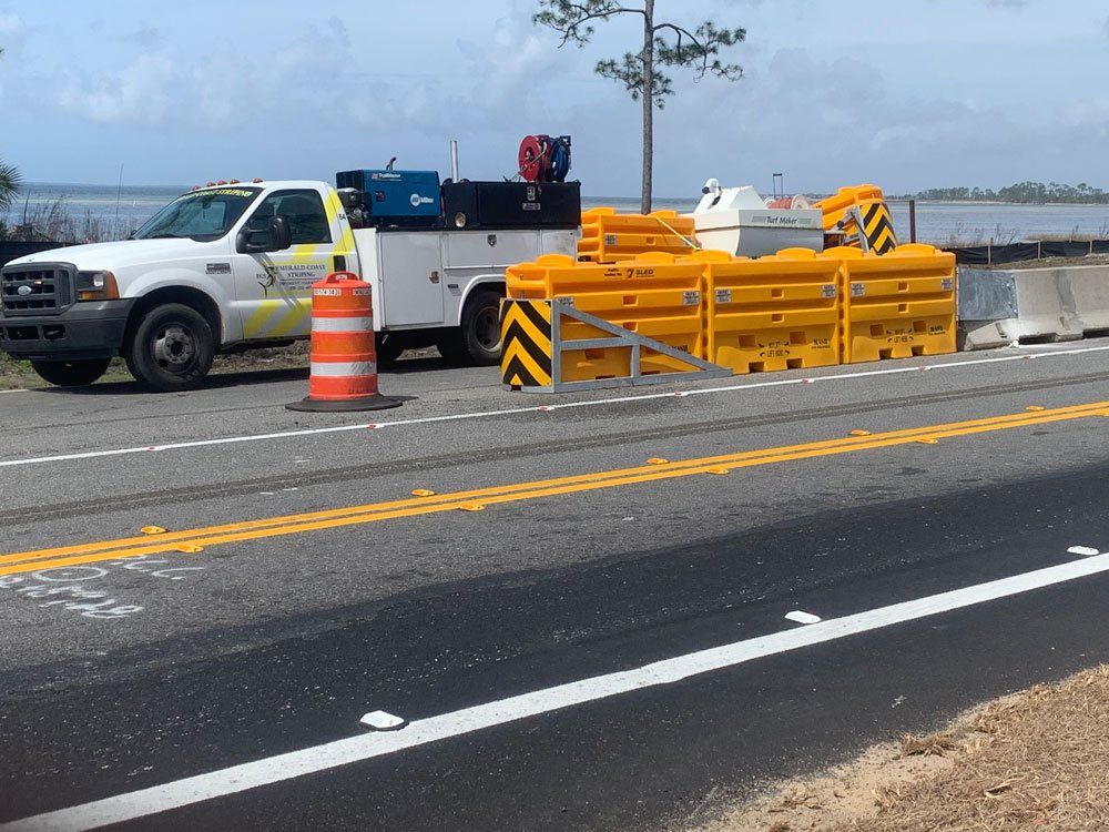 Car on The Side of The Road with Traffic Barrel — Pensacola, FL — Emerald Coast Striping